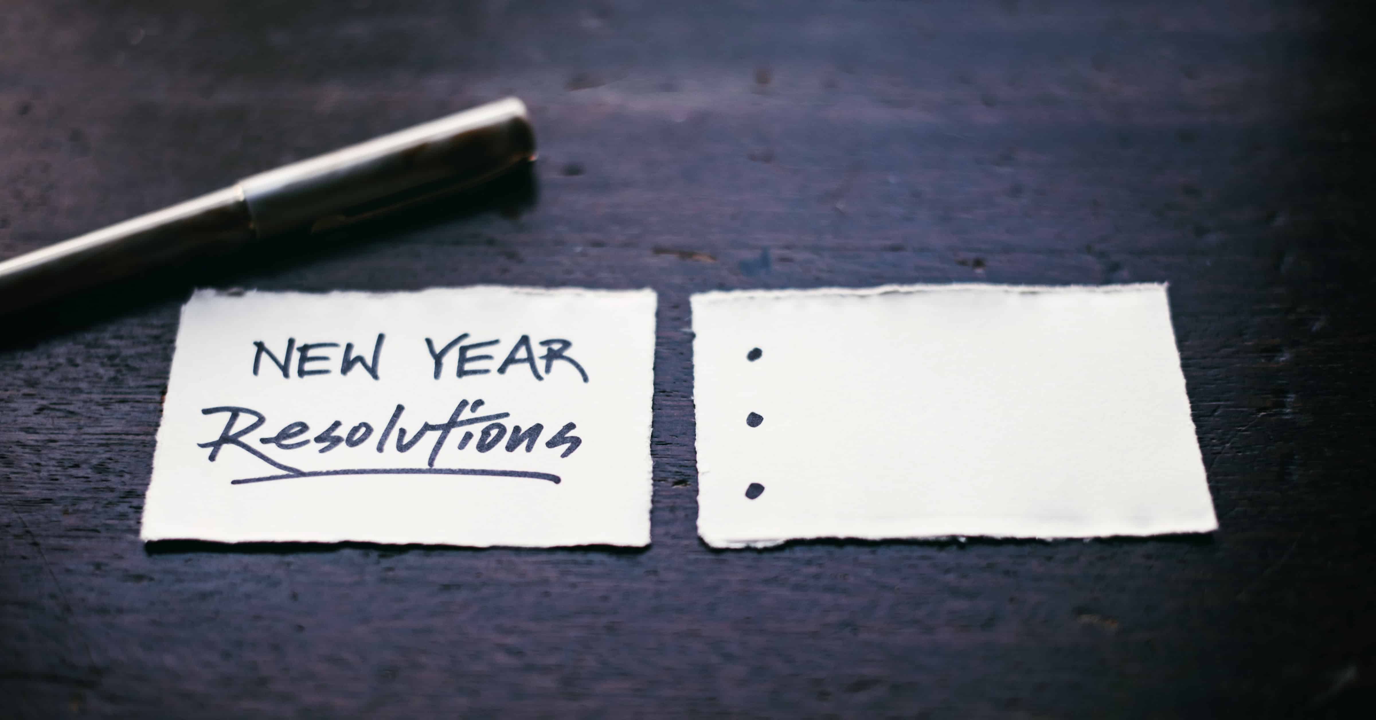 New Year Resolutions - stock image of pen with index cards for writing resolutions
